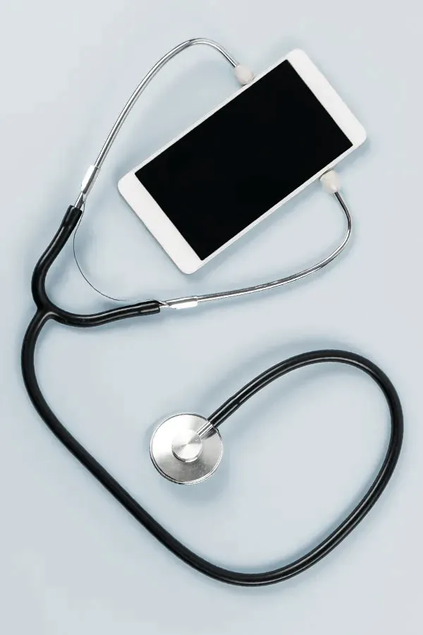 Telemedicine-Treatment A smartphone with a stethoscope attached to it, symbolizing Telemedicine treatment from Julie Kane, NP of Trua Health & Wellness in Alaska.