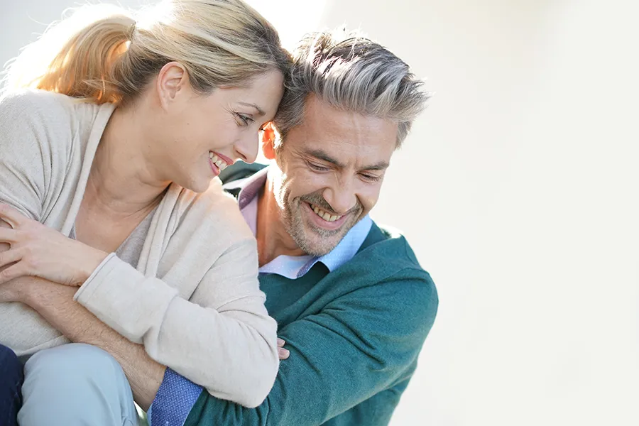 Wellness-Services-Doctor-2 A middle-aged couple embracing against a white background, enjoying health due to health and wellness services provided by Julie Kane, NP of Trua Health & Wellness in Alaska.